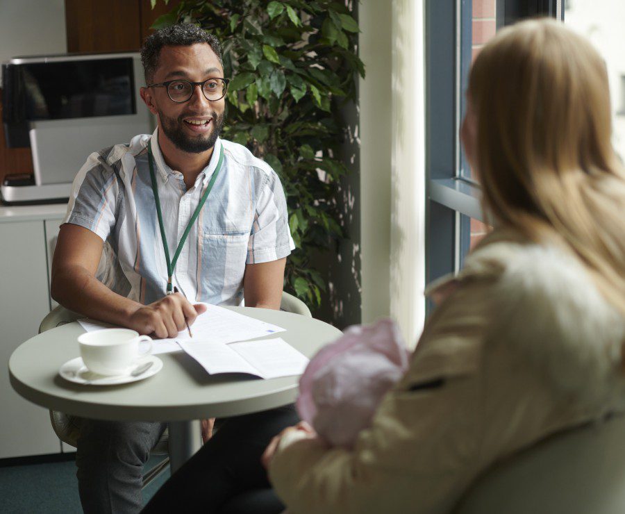 Two people talking at a table.