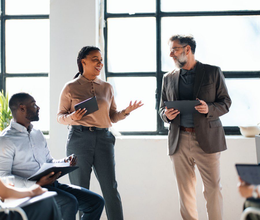 Business meeting with people holding tablets.